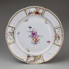 Plate - with relief and painted decoration