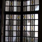 Architectural photograph - Stained glass door opening from the stairwell onto the open corridor of the fifth floor, Kasselik House (Budapest, 3 Vörösmarty Square)