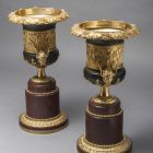 Pair of urns - depicting bacchanal scenes, with porphyry base