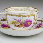 Tea cup and saucer - decorated with painted flower bouquets and relief-gild