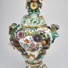 Ornamental vase with lid - with sculptural flowers, fruits, insects and putti