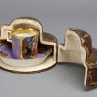 Cup and saucer - With the figures of Apollo and a centaur; in leather case